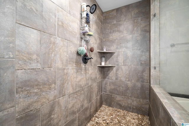 full bath featuring a tile shower