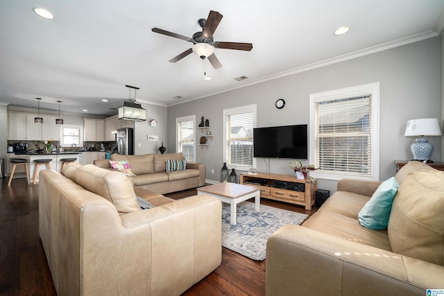 living room with recessed lighting, ceiling fan, ornamental molding, and dark wood-style flooring
