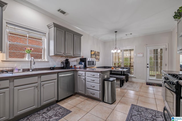 471 River Oaks Ln, Helena, AL 35080 - kitchen featuring stainless steel appliances, gray cabinets, dark countertops, a sink, and a chandelier