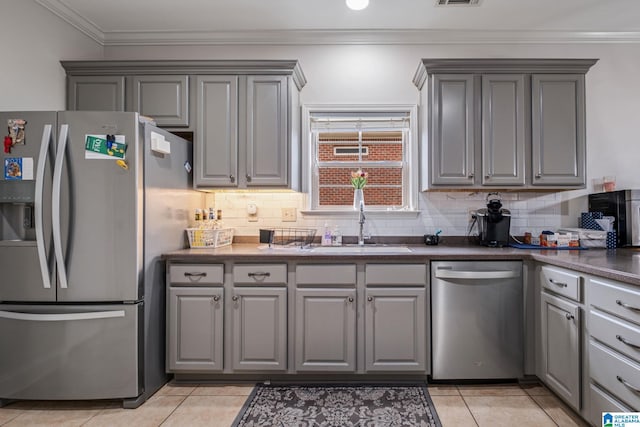 471 River Oaks Ln, Helena, AL 35080 - kitchen featuring stainless steel appliances, gray cabinets, a sink, dark countertops, and ornamental molding