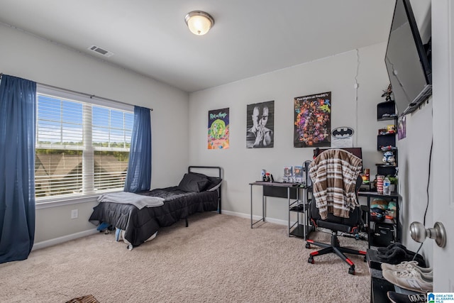 carpeted bedroom featuring visible vents and baseboards