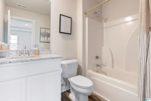 full bath featuring shower / bathtub combination with curtain, vanity, toilet, visible vents, and wood finished floors
