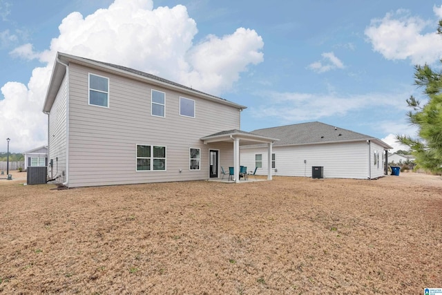 rear view of house featuring central AC and a patio area