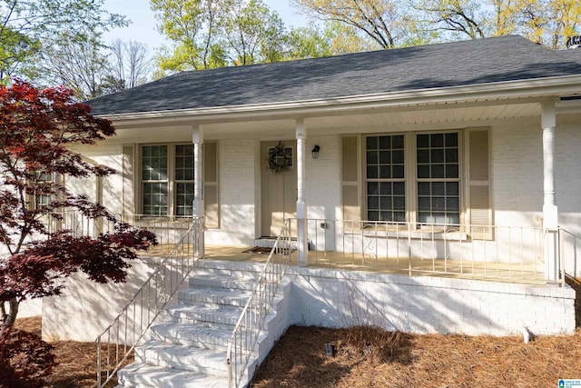 1324 W Navajo Dr, Alabaster, AL 35007 - view of exterior entry with brick siding, a porch, and a shingled roof