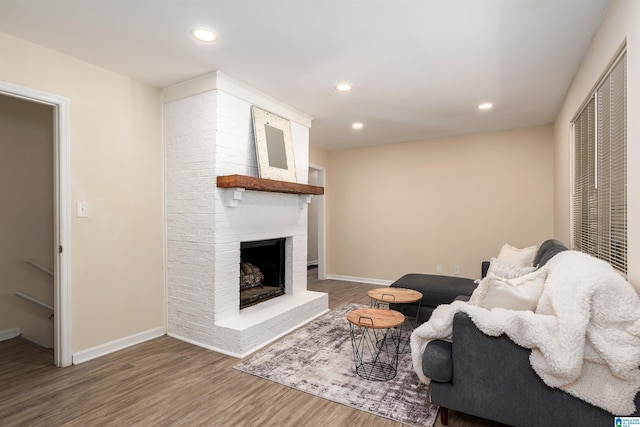 1324 W Navajo Dr, Alabaster, AL 35007 - living room featuring wood finished floors, baseboards, a brick fireplace, and recessed lighting