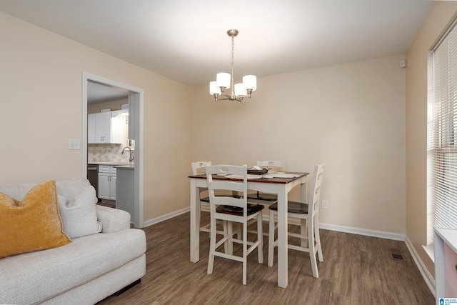 1324 W Navajo Dr, Alabaster, AL 35007 - dining space with a notable chandelier, baseboards, visible vents, and wood finished floors