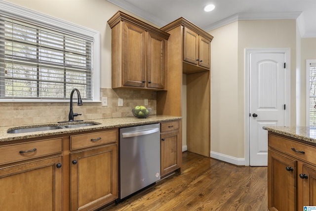 kitchen with dishwasher, brown cabinets, a sink, dark wood-style floors, and backsplash