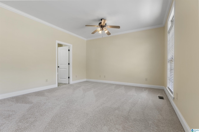 empty room featuring light carpet, baseboards, ceiling fan, and ornamental molding