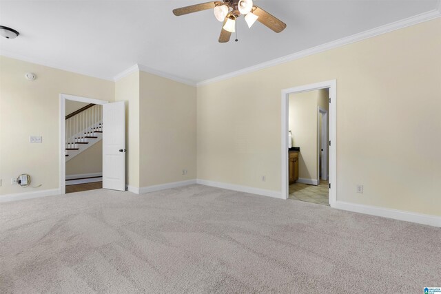 interior space with baseboards, stairs, ceiling fan, and crown molding