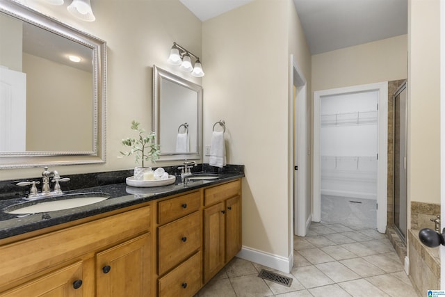 full bath featuring a sink, a shower stall, and visible vents