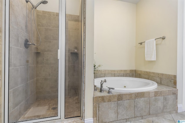 bathroom with a bath, tile patterned floors, and a shower stall