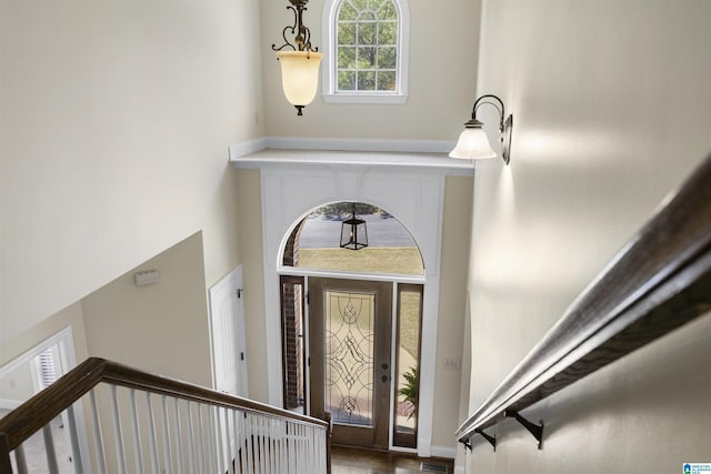 entryway with stairs and a high ceiling