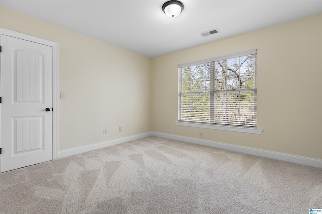 unfurnished room with baseboards, visible vents, and carpet flooring