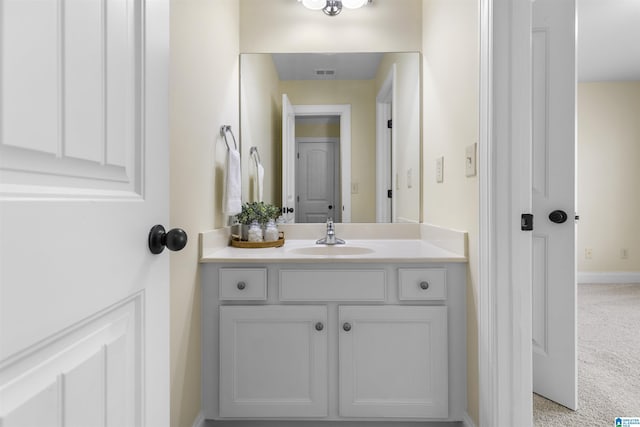 bathroom featuring baseboards, visible vents, and vanity