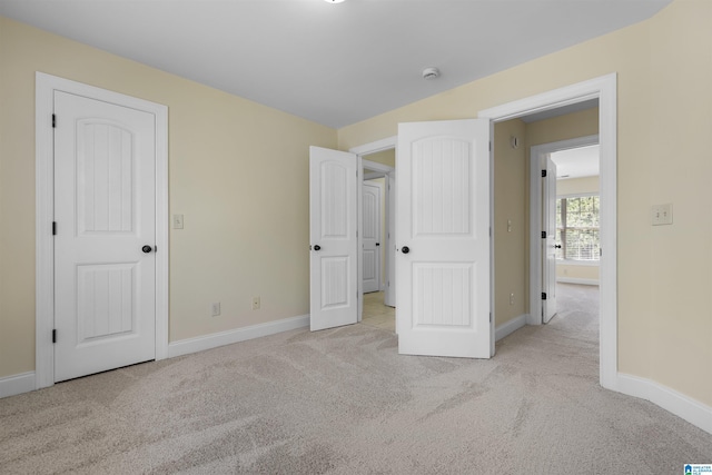 unfurnished bedroom featuring baseboards and carpet floors