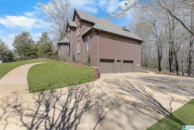 view of side of property featuring roof with shingles, concrete driveway, an attached garage, brick siding, and a lawn