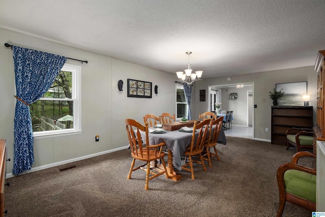 470 16th St, Calera, AL 35040 - dining space featuring a textured ceiling, visible vents, baseboards, carpet floors, and an inviting chandelier
