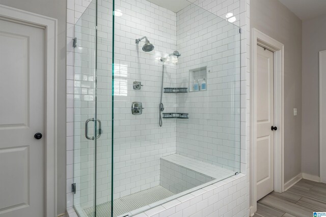 4460 Tuckahoe Ln, Hoover, AL 35226 - full bathroom featuring baseboards, a stall shower, and wood finished floors