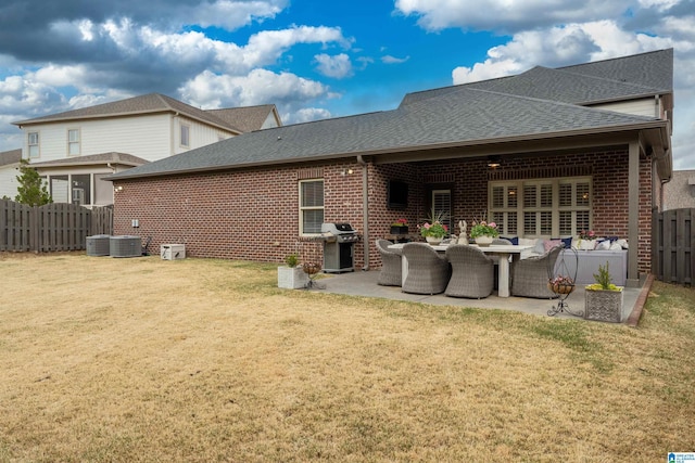 4460 Tuckahoe Ln, Hoover, AL 35226 - back of property with a fenced backyard, a lawn, a patio, brick siding, and a shingled roof