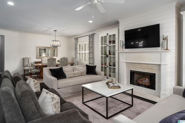 4460 Tuckahoe Ln, Hoover, AL 35226 - living room featuring recessed lighting, a brick fireplace, ceiling fan with notable chandelier, and crown molding