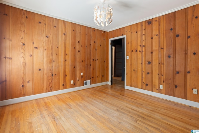 5605 7th Ave S, Birmingham, AL 35212 - spare room featuring wood finished floors, visible vents, baseboards, and a notable chandelier