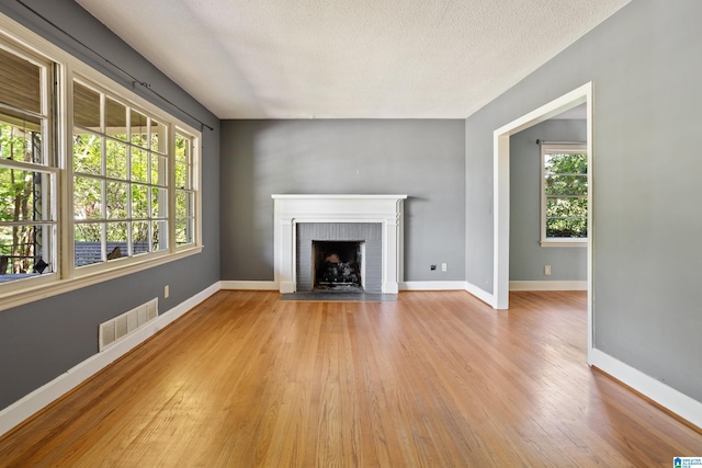 5605 7th Ave S, Birmingham, AL 35212 - unfurnished living room with light wood-type flooring, visible vents, and a wealth of natural light