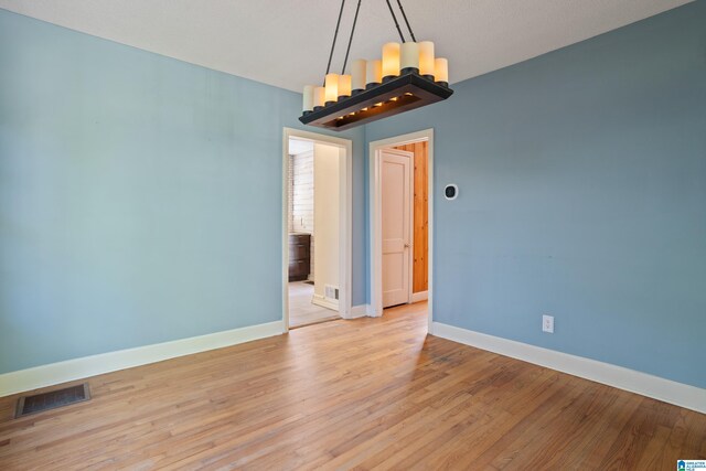 5605 7th Ave S, Birmingham, AL 35212 - unfurnished room with baseboards, visible vents, and light wood-type flooring
