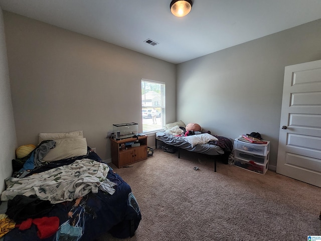 carpeted bedroom with visible vents
