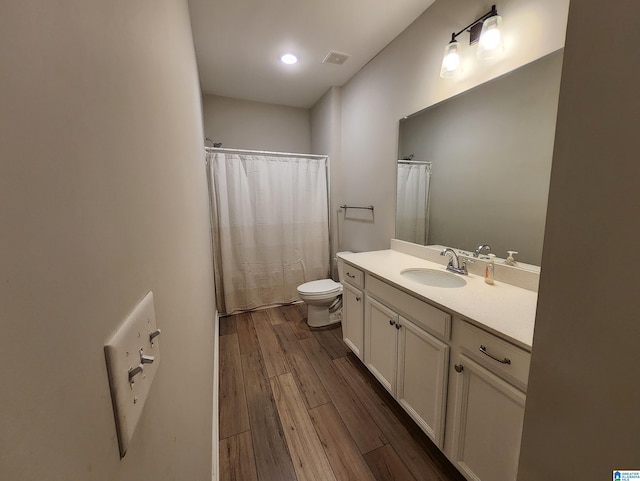 bathroom with vanity, recessed lighting, toilet, wood finished floors, and a shower with shower curtain