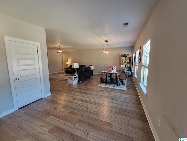 dining space with visible vents, baseboards, and wood finished floors