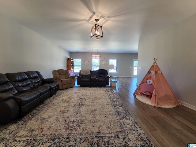 living room with a healthy amount of sunlight, baseboards, and wood finished floors