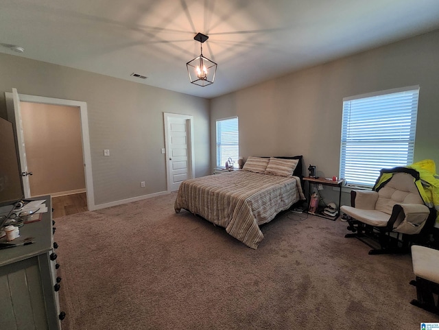 carpeted bedroom with visible vents and baseboards