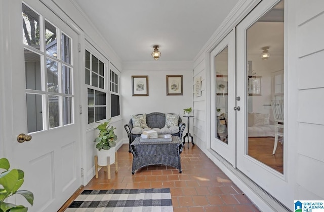 sunroom / solarium featuring french doors and crown molding