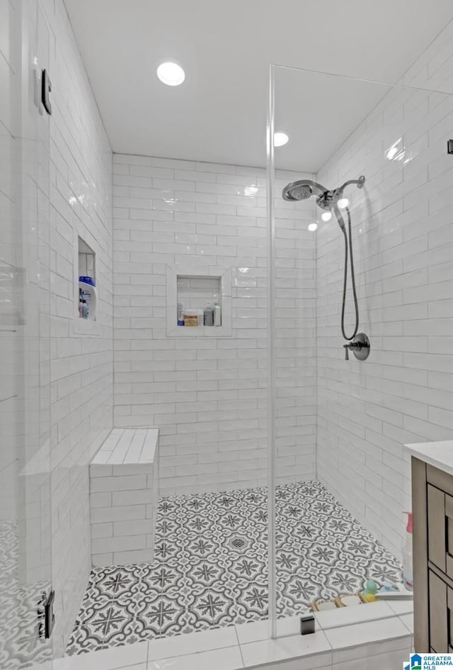 full bathroom featuring a stall shower and vanity