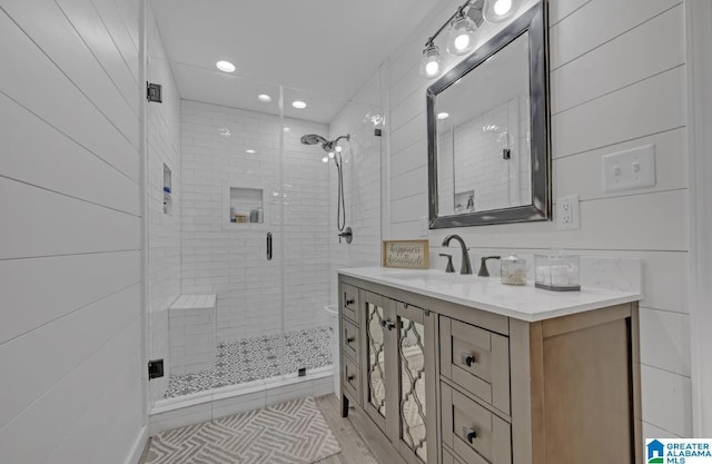 bathroom featuring a stall shower, recessed lighting, and vanity