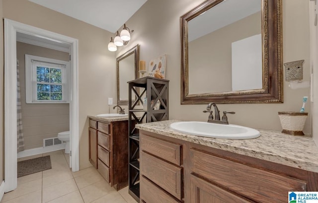 full bathroom with toilet, a sink, two vanities, and visible vents