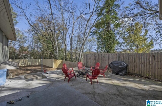 view of patio featuring an outdoor fire pit, a fenced backyard, and grilling area