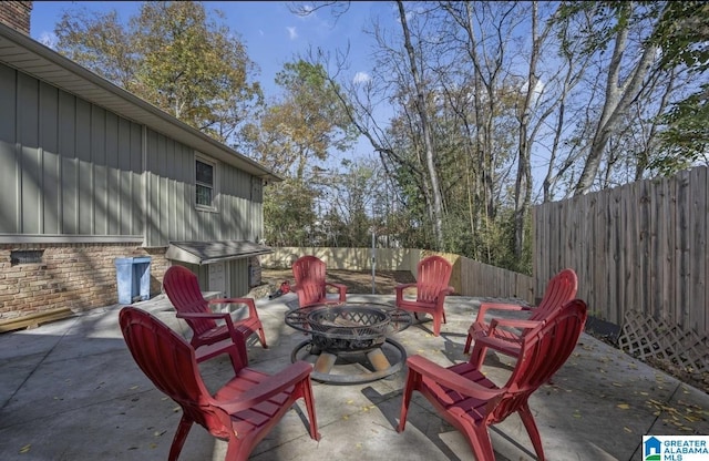 view of patio featuring a fenced backyard and an outdoor fire pit