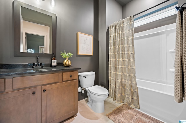 full bath with toilet, shower / bath combo with shower curtain, and vanity