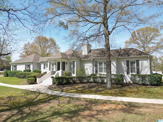 2240 Hillview Rd, Birmingham, AL 35022 - view of front of property with a chimney, a front yard, and brick siding