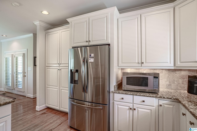 2240 Hillview Rd, Birmingham, AL 35022 - kitchen with tasteful backsplash, appliances with stainless steel finishes, crown molding, white cabinetry, and light wood-style flooring