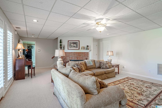 2240 Hillview Rd, Birmingham, AL 35022 - living room featuring a fireplace, a paneled ceiling, light colored carpet, and baseboards