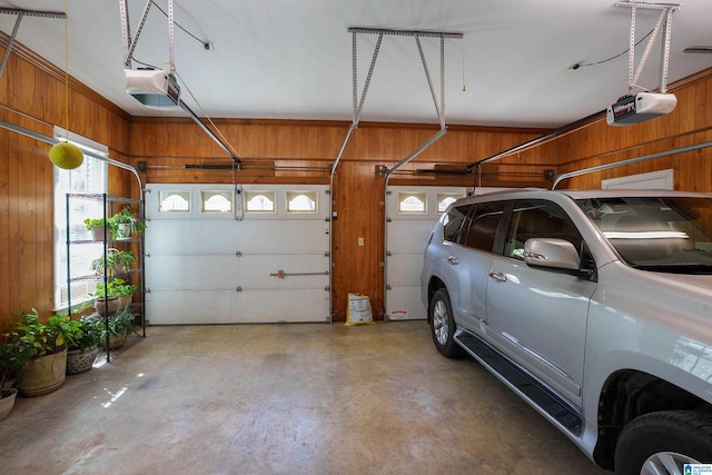2240 Hillview Rd, Birmingham, AL 35022 - garage with wood walls and a garage door opener