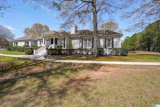 2240 Hillview Rd, Birmingham, AL 35022 - view of front of home with a chimney, a front lawn, and covered porch