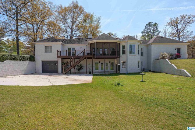 2240 Hillview Rd, Birmingham, AL 35022 - back of property with stairs, a yard, a sunroom, and an attached garage