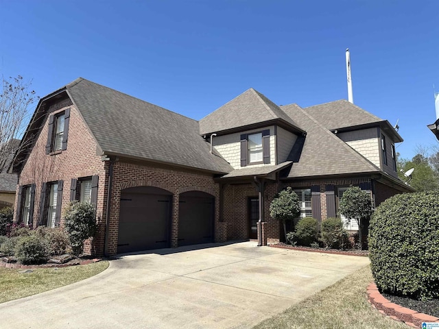 2217 Chalybe Dr, Hoover, AL 35226 - view of front of house featuring a shingled roof, concrete driveway, a garage, and brick siding
