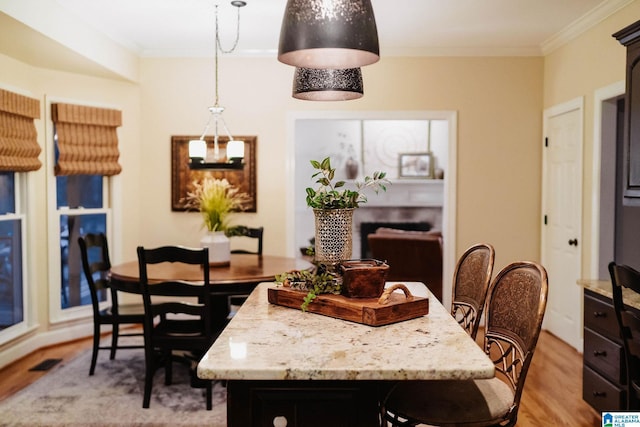 100 Edgewood Cir, Oneonta, AL 35121 - dining area with visible vents, ornamental molding, and light wood-style flooring