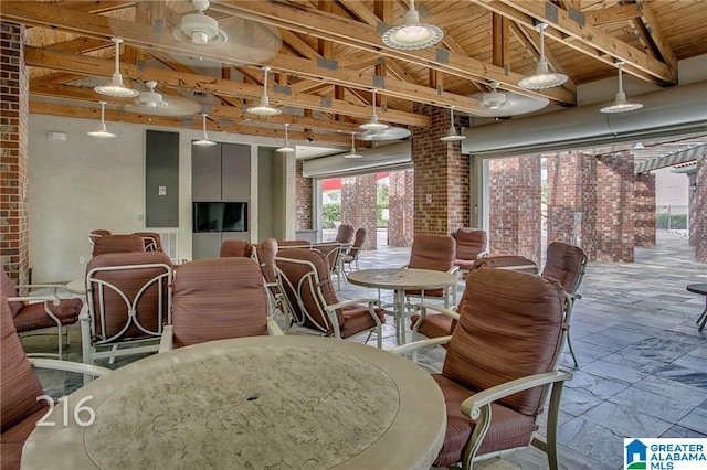600 13th St E Unit 914, Tuscaloosa, AL 35401 - dining room featuring healthy amount of natural light, stone tile flooring, wood ceiling, and brick wall