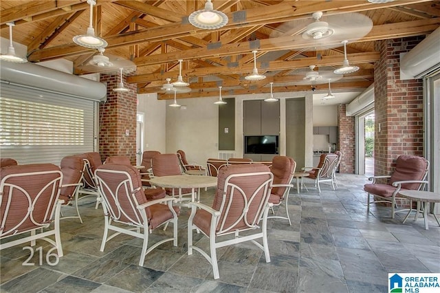 600 13th St E Unit 914, Tuscaloosa, AL 35401 - dining space with wood ceiling, stone tile flooring, and brick wall