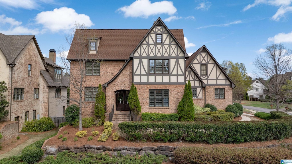 4357 Boulder Lake Cir, Vestavia Hills, AL 35242 - tudor home featuring a shingled roof, stucco siding, and brick siding